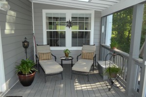 A screened in porch with a table and chairs for painters in Asheville, NC.