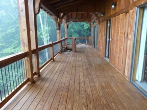 A serene wooden deck nestled amongst the trees, perfect for painters in Asheville, NC to find inspiration in the surrounding natural beauty.